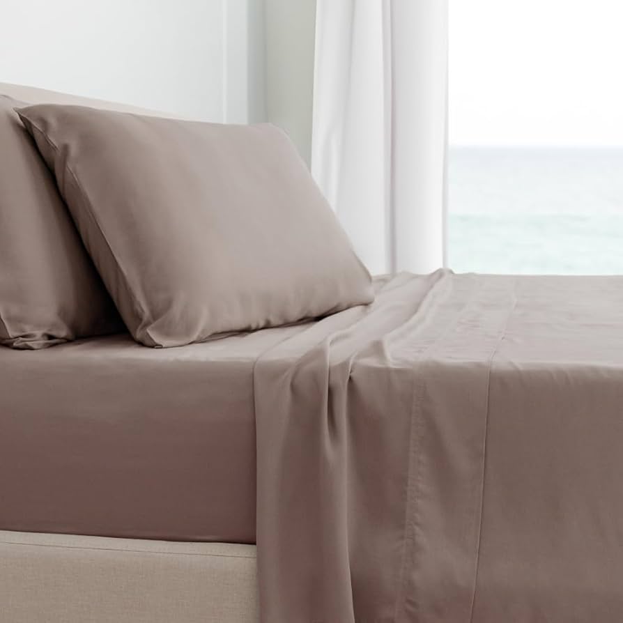 Cariloha Classic Bamboo Bed Sheet Set laid flat on a white studio bed with one corner folded to show fabric drape and stitching detail