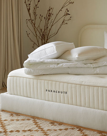 Close-up macro photo brief for Parachute Classic Percale Sheet Set showing weave texture and moisture dispersion pattern under angled lighting