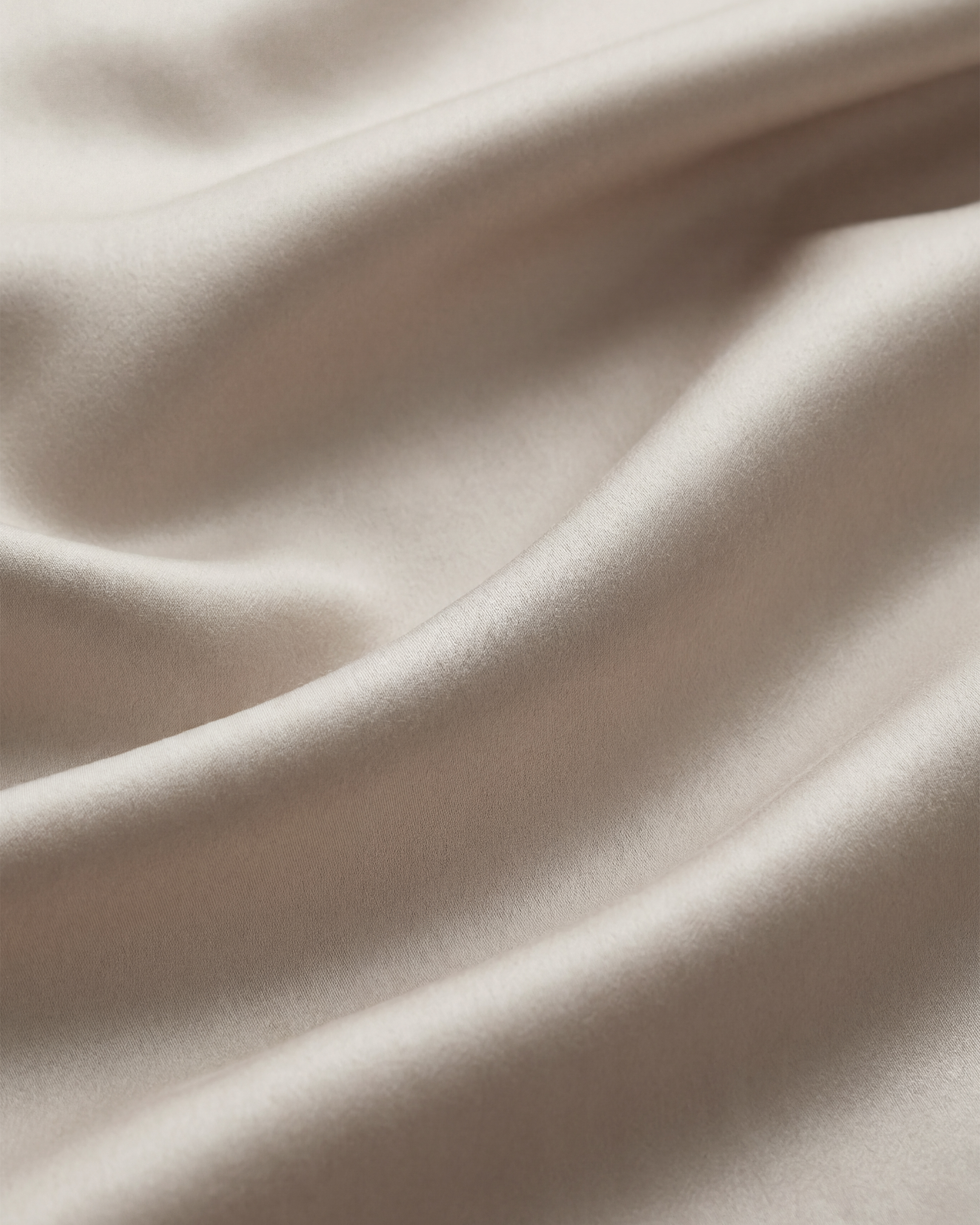Close-up macro photo brief for Quince Bamboo Sheet Set showing weave texture and moisture dispersion pattern under angled lighting